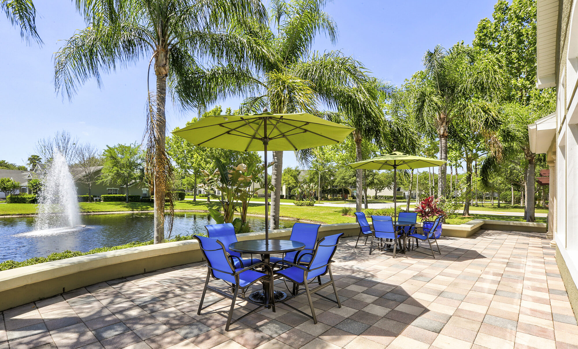 Sitting area beside the pond with tables and chairs