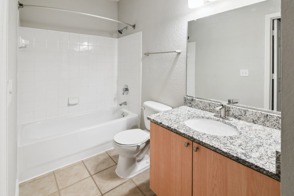 a bathroom with a toilet and a tub and a sink