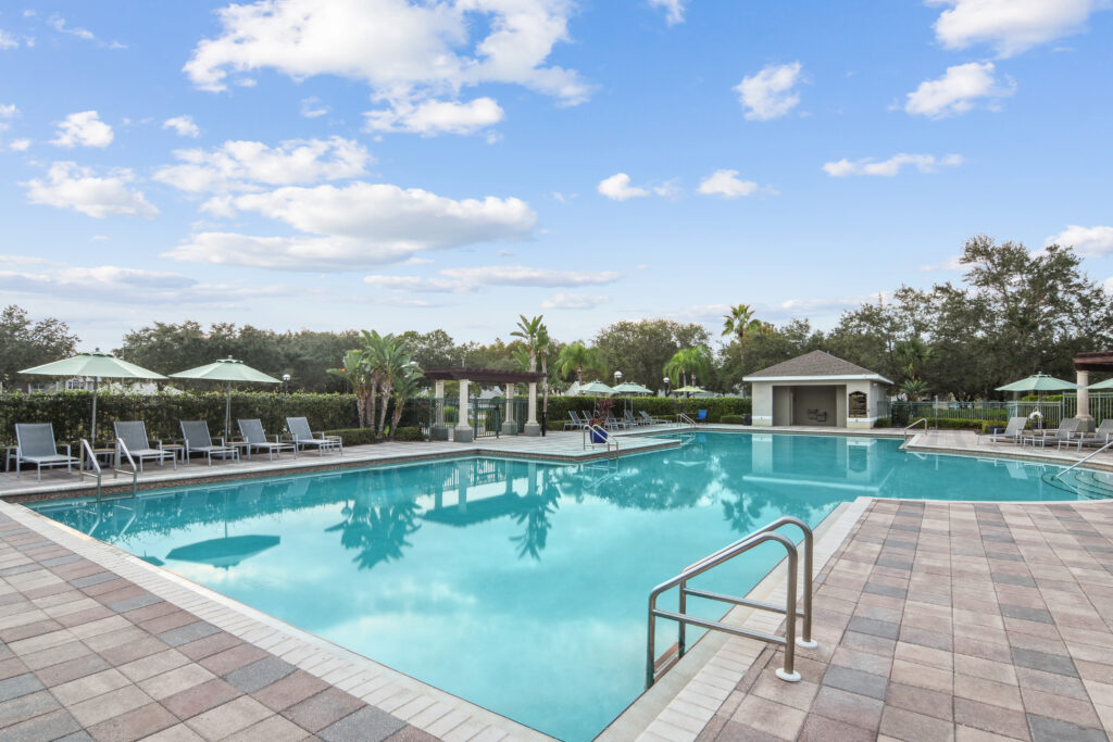 pool with deck seating and shade umbrellas