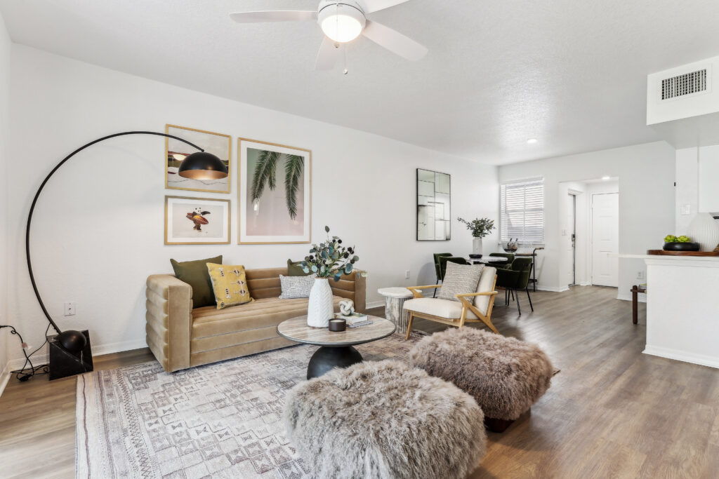 Living room with couch seating, ceiling fan, and wood-style flooring